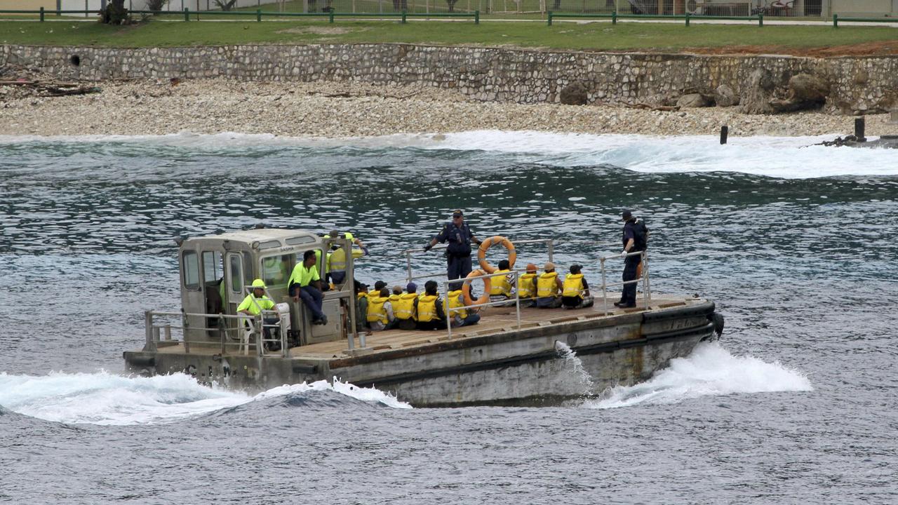 A group of Vietnamese asylum seekers are taken by barge to a jetty on Australia's Christmas Island. Picture: AP