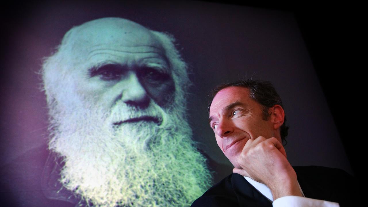 Chris Darwin, great great grandson of naturalist and author Charlies Darwin who published his theory for evolution in 1859 book On The Origin of Species, stands next to a famous portrait of his ancestor at launch of Genographic project revealing Darwin's 60,000 year ancestry, proving that Charles Darwin's ancestors were from Africa, at the Australian Museum in Sydney.