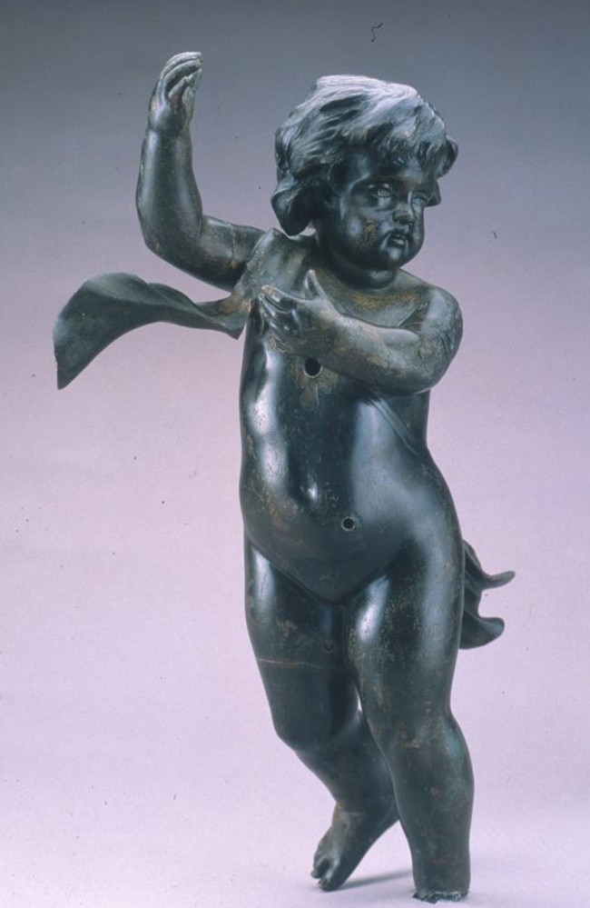 This cherub is perhaps one of the most recognised in the collection of Titanic artefacts. This bronze cherub was recovered in 1987 and is missing its left foot. This loss most likely occurred when the cherub was ripped from the staircase post it adorned. Picture: RMS Titanic, Inc.