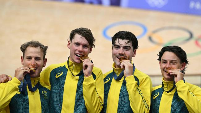 Gold medallists (from L) Australia's Sam Welsford, Australia's Kelland O'brien, Australia's Conor Leahy and Australia's Oliver Bleddyn pose  on the podium of the men's track cycling team pursuit event of the Paris 2024 Olympic Games at the Saint-Quentin-en-Yvelines National Velodrome in Montigny-le-Bretonneux, south-west of Paris, on August 7, 2024. (Photo by SEBASTIEN BOZON / AFP)