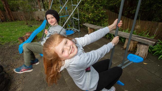 Rafferty and Jazmin Forbes enjoy their new swing set. Picture: Tony Gough