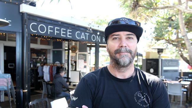 Pierre Mortensen, owner of Kings Beach cafe Coffee Cat, says trade had suffered since his business was listed as an exposure site. Picture: Steve Pohlner