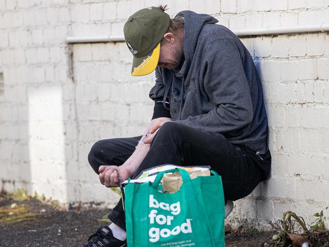 Drug users blatantly inject drugs in the streets of Richmond after collecting needle from the Safe Injecting Room, Richmond VIC 3121, Australia. Picture: Jason Edwards