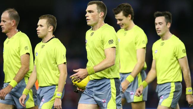 How do four umpires come up with the same interpretations, in particular with the very grey holding-the-ball rule? Picture: Michael Dodge/Getty Images/AFL Media