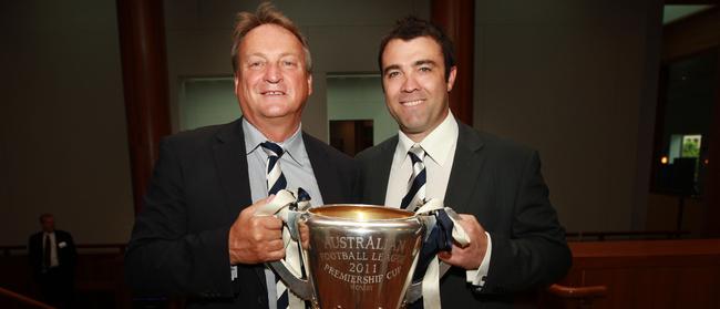 Brian Cook and Geelong's Coach Chris Scott with the premiership cup at a dinner at Parliament House in Canberra.