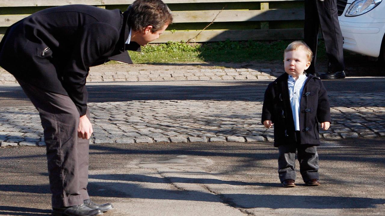 Crown Prince Frederik tries to convince Prince Christian to keep walking on his first day of nursery in Denmark. Picture: John McConnico/AP