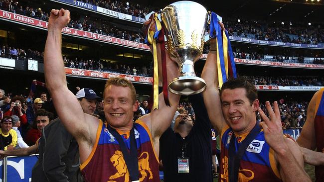 Brisbane Lions captain Michael Voss and Craig McCrae celebrate winning the 2003 AFL Premiership Cup at the MCG.