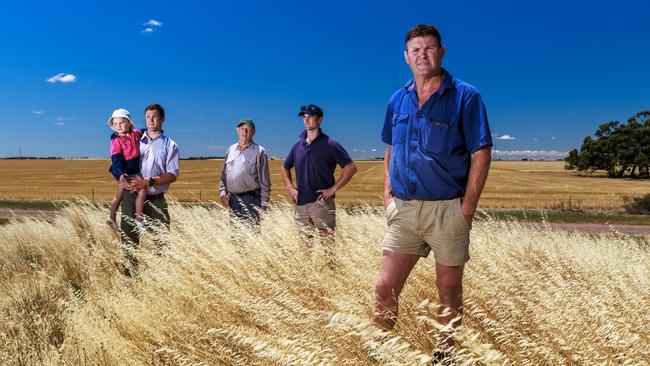 27/11/2023 Farmer Chris Johns (right) pictured with his family (L-R) Mitch, holding his daughter Evie (4), dad Max (86) and Lachie on their property in Dooen near Horsham in western Victoria. Aaron Francis / The Australian