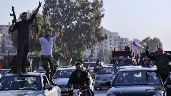 Syrian soldiers dance as they chant slogans against US President Trump during demonstrations following a wave allied strikes to punish President Bashar Assad.