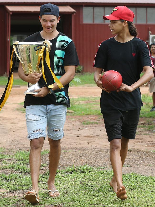 Daniel Rioli walks the cup through town with his younger brother Brayden. Picture: Michael Klein