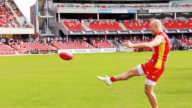 Gary Ablett kicking the first goal at Metricon Stadium in May 2011.