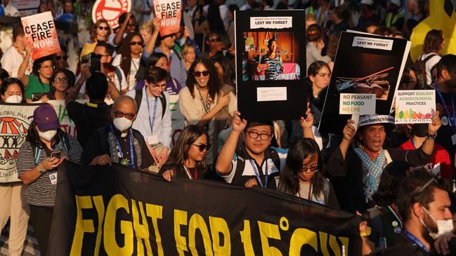 Activists, including some holding a banner that reads ‘Fight for 1.5 degrees Celsius’, march in protest at the COP28 climate conference in Dubai on Saturday. Protesters also demanded a ceasefire in Gaza, global climate justice and a variety of other human rights and climate causes. Picture: Getty Images