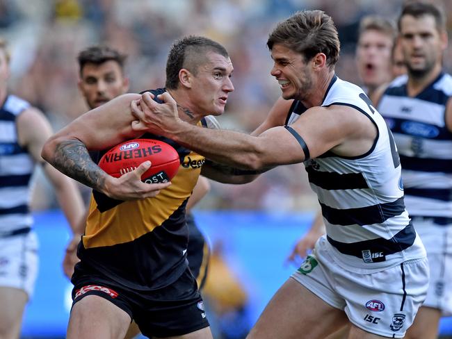 Tom Hawkins of the Cats tackles Dustin Martin of the Tigers, during the round 5 AFL match between the Richmond Tigers and Geelong Cats, at the MCG in Melbourne, Saturday May 2, 2015. (AAP Image/Joe Castro) NO ARCHIVING, EDITORIAL USE ONLY