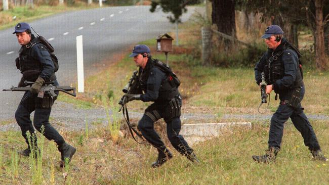 Special Operations police run for cover at the shooting scene near historic Port Arthur.