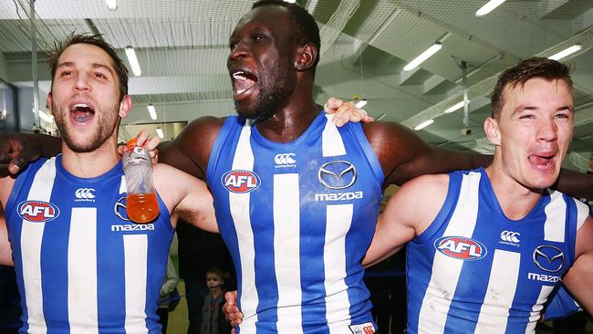 Majak Daw, centre, celebrates with teammates Jamie Macmillan, left, and Kayne Turner after a Kangaroos win in July. Picture: Getty Images