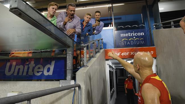 Gary Ablett talks to an angry Gold Coast fan after the game.