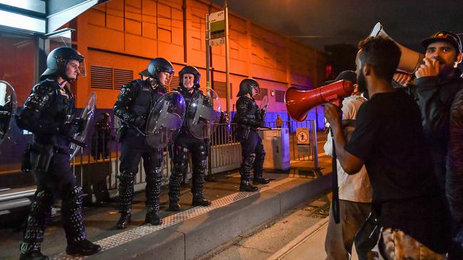 Riot police attempt to hold back protesters. Picture: Jake Nowakowski