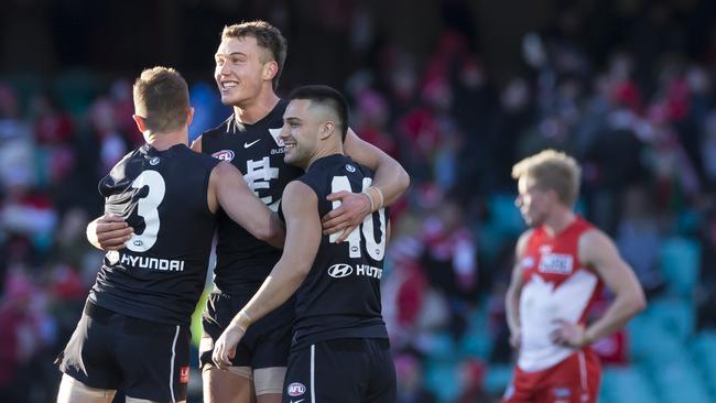 Marc Murphy, Patrick Cripps and Michael Gibbons celebrate Carlton’s win. Picture: AAP Image/Craig Golding.