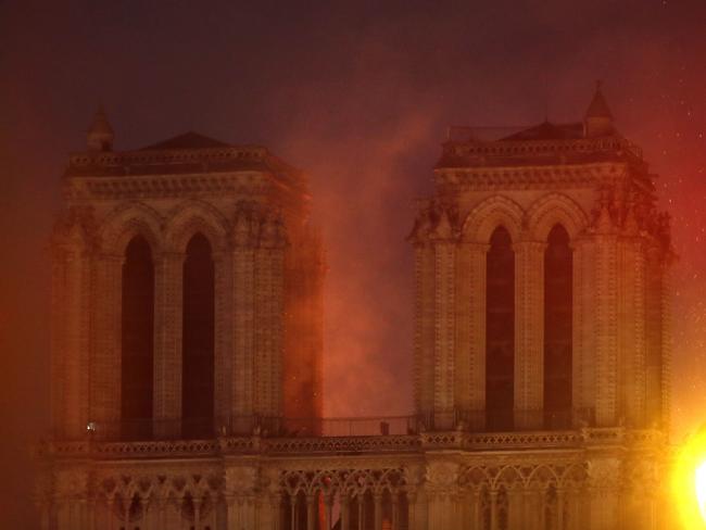 Flames illuminate the night sky as Notre Dame cathedral burns in Paris, Monday, April 15, 2019. (AP Photo/Thibault Camus)