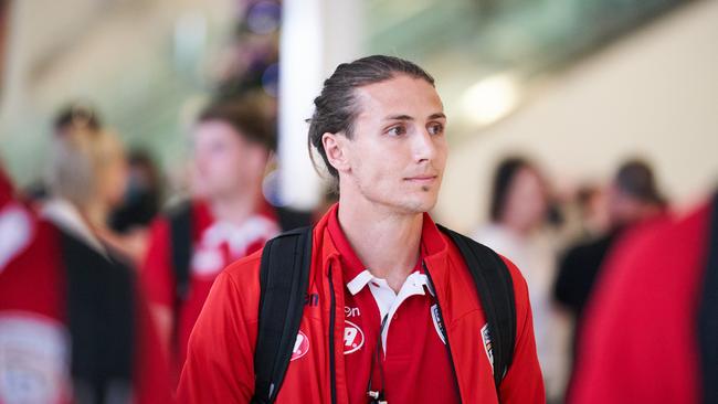 Michael Marrone arrives at Adelaide Airport with the Reds on Wednesday. Picture: AAP Image/Matt Loxton