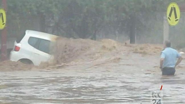 A car is trapped in flash flooding in Toowoomba, where at least eight people have died. Picture: ABC