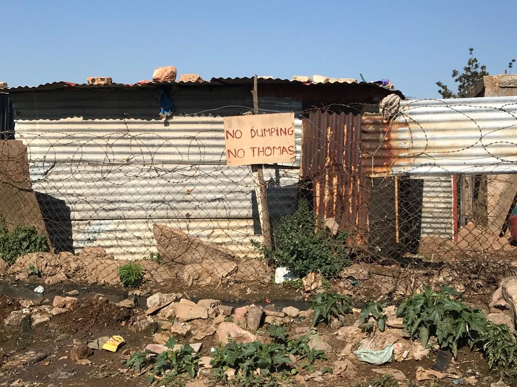 Rubbish is strewn around despite the ‘no dumping’ signs.