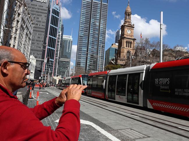 People stop to watch a light rail test from Town Hall to Circular Quay. Picture: Brett Costello