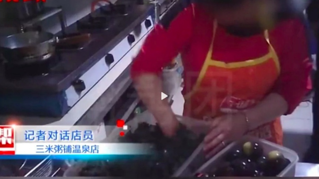 Video showed kitchen staff rummaging through leftovers from discarded meals. Picture: Fujian Television.