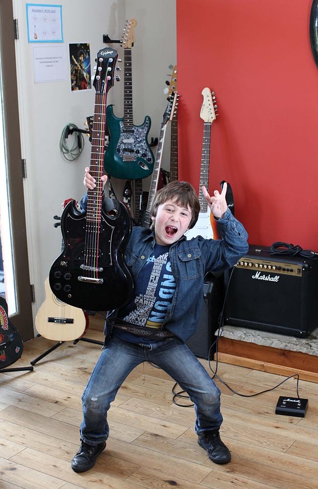 Don’t fret, mum and dad, this video game is making me a mini rock star. Source: MIKE JONES/ CATERS NEWS