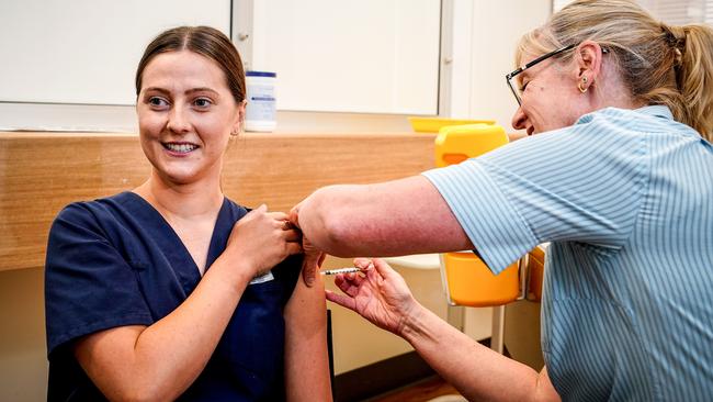 SA emergency department nurse Emily Hooper gets her Pfizer vaccination from Nurse Unit Manager Maryanne Attard in March. Picture: Mike Burton