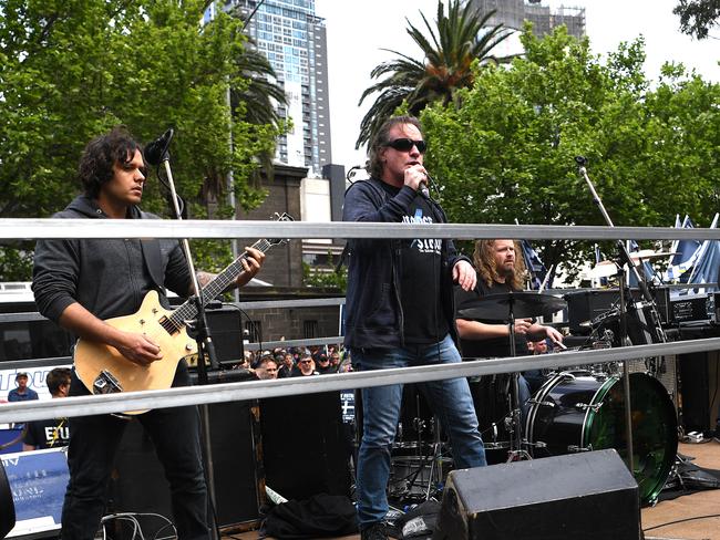 AC/DC cover band Thunderstruck performs to thousands of people at the Change The Rules rally. Picture: AAP/Julian Smith