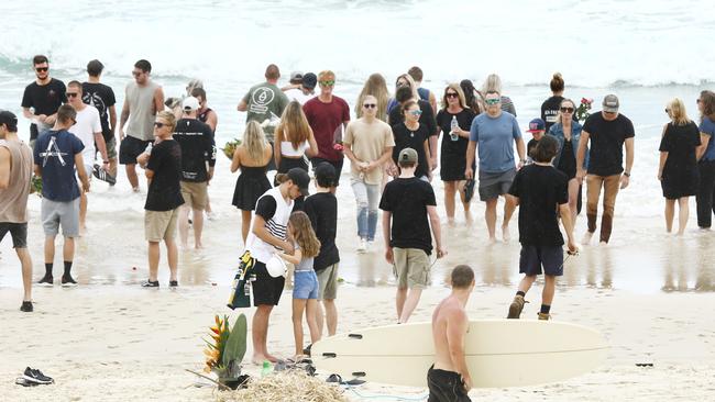 Family and friends hold a memorial for Dylan Carpenter at Fingal beach where the young surfer died. Picture: Glenn Hampson