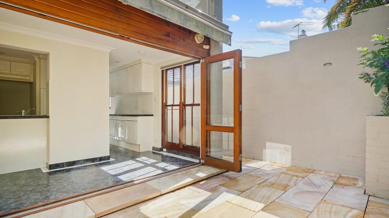 The terrace comprises of an open plan living/dining space leading through to an eat-in kitchen and a paved outdoor courtyard. Source: realestate.com.au