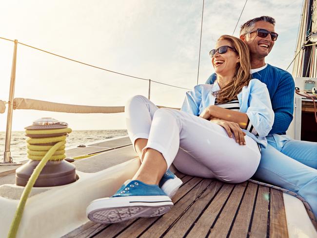 Shot of a couple enjoying a boat cruise out on the ocean; rich wealthy generic