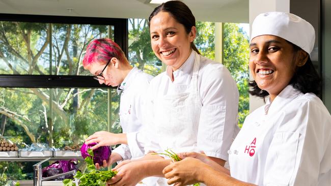 Tasting Australia food curator Emma McCaskill (centre) helping Adelaide Botanic High School students pick up new skills in the kitchen as part of an Adelaide Institute of Hospitality course providing pathways into the industry for young people. Photo Morgan Sette/ The Advertiser.