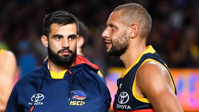 Wayne Milera with his arm in a sling talks to Cam Ellis-Yolmen after the big win against Gold Coast. Picture: Daniel Kalisz/Getty Images