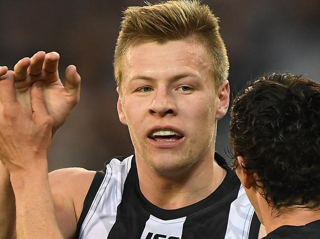 Jordan de Goey (left) and Scott Pendlebury of the Magpies react after De Goey kicked a goal during the Round 11 AFL match between the Collingwood Magpies and the Fremantle Dockers at the MCG in Melbourne, Sunday, June 3, 2018. (AAP Image/Julian Smith) NO ARCHIVING, EDITORIAL USE ONLY