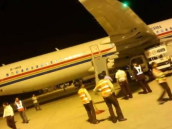 Bizarre ... the plane had almost finished taxiing when the man opened one of the doors, automatically deploying the emergency slide. Picture: YouTube/China View