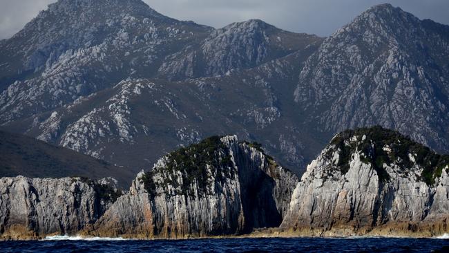 Breaksea Islands framed by Mounts Berry and Stokes at Port Davey in Tasmania's Southwest National Park as part of the World Heritage Wilderness Area. Picture: PETER MARMION