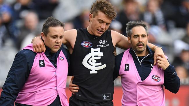 Patrick Cripps in the hands of trainers after being booted in the leg against the Dees on the weekend. Picture: AAP