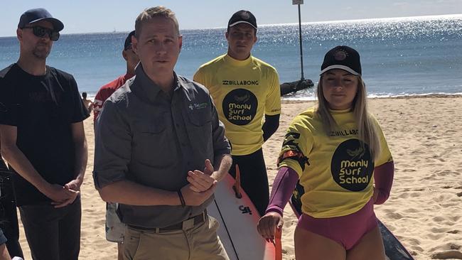 Mike Brewer (left), from Tacmed Australia, demonstrating how to apply a tourniquet, from the kit, to the arm of Manly Surf School instructor Bella Grainger. Picture: Jim O'Rourke