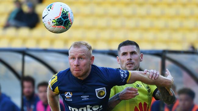 Ziggy Gordon of the Mariners, left, holds back Gary Hooper of the Phoenix. Picture: AAP Image/SNPA