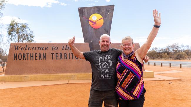 Darwin couple Annette and Barry Bansgrove were thrilled to cross the NT/SA border at 1.00pm on Tuesday before new entry restrictions came into play at 4pm. Photo: EMMA MURRAY