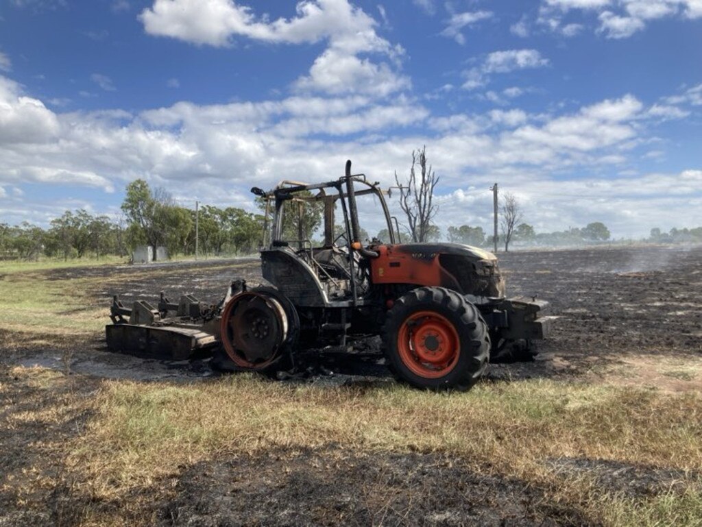 Emergency services were working to put out a grassfire and heavy machinery fire, which might have been started by it catching fire or exploding in a paddock next to several houses. Picture: Pamela McKay