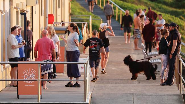 Customers enjoy a coffee outside Gusto coffee at Curl Curl beach, Sydney. Picture: Matrix