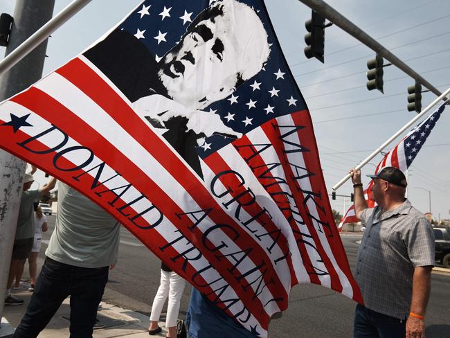 Protesters rally against a mask mandate, many showing support for US President Donald Trump, in Las Vegas, Nevada on August 22, 2020. - "On day one" of his own presidency, Democratic presidential nominee Joe Biden said, he would implement a national COVID-19 plan and mandate mask wearing. (Photo by Bridget BENNETT / AFP)