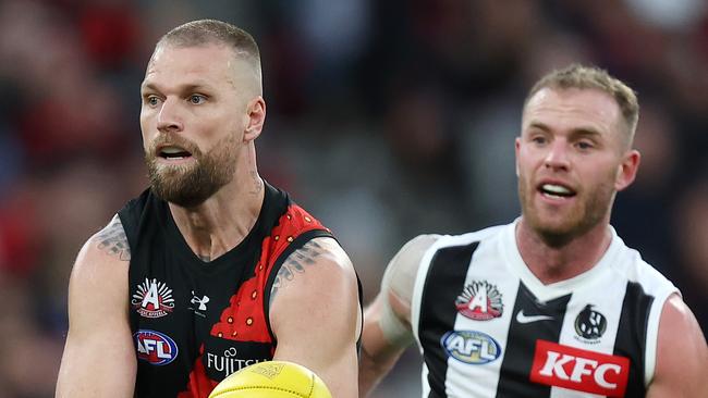 MELBOURNE, APRIL 25, 2024: 2024 AFL Football Round 7 - Anzac Day Match - Essendon V Collingwood at the MCG. Jake Stringer under pressure from Tom Michell. Picture: Mark Stewart