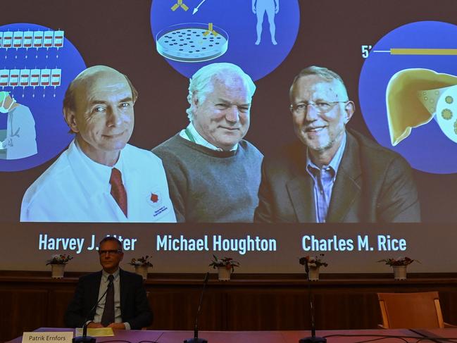 Nobel Committee member Patrik Ernfors sits in front of a screen displaying the winners of the 2020 Nobel Prize in Physiology or Medicine, (L-R) American Harvey Alter, Briton Michael Houghton and American Charles Rice, during a press conference at the Karolinska Institute in Stockholm, Sweden, on October 5, 2020. - Americans Harvey Alter and Charles Rice as well as Briton Michael Houghton win the 2020 Nobel Medicine Prize for the discovery of Hepatitis C virus. (Photo by Jonathan NACKSTRAND / AFP)