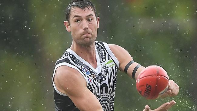 Palmerston skipper Matt Dennis fires out a handpass in the game against the Tiwi Bombers on Bathurst Island. Picture: Celina Whan AFLNT/Media