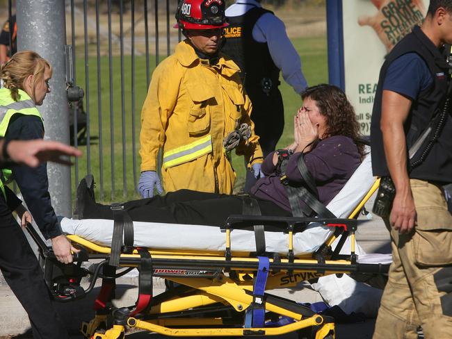 Horrific ... A victim is wheeled away on a stretcher following the shooting. Picture: David Bauman/The Press-Enterprise via AP